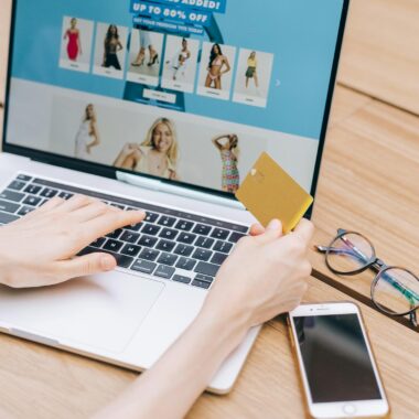 Person shopping online using a laptop and credit card, lifestyle technology concept.